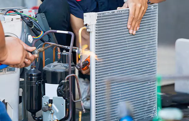 Outdoor commercial HVAC units on a rooftop with a banner reading. How to Maintain Peak HVAC Performance in Low Temperatures.